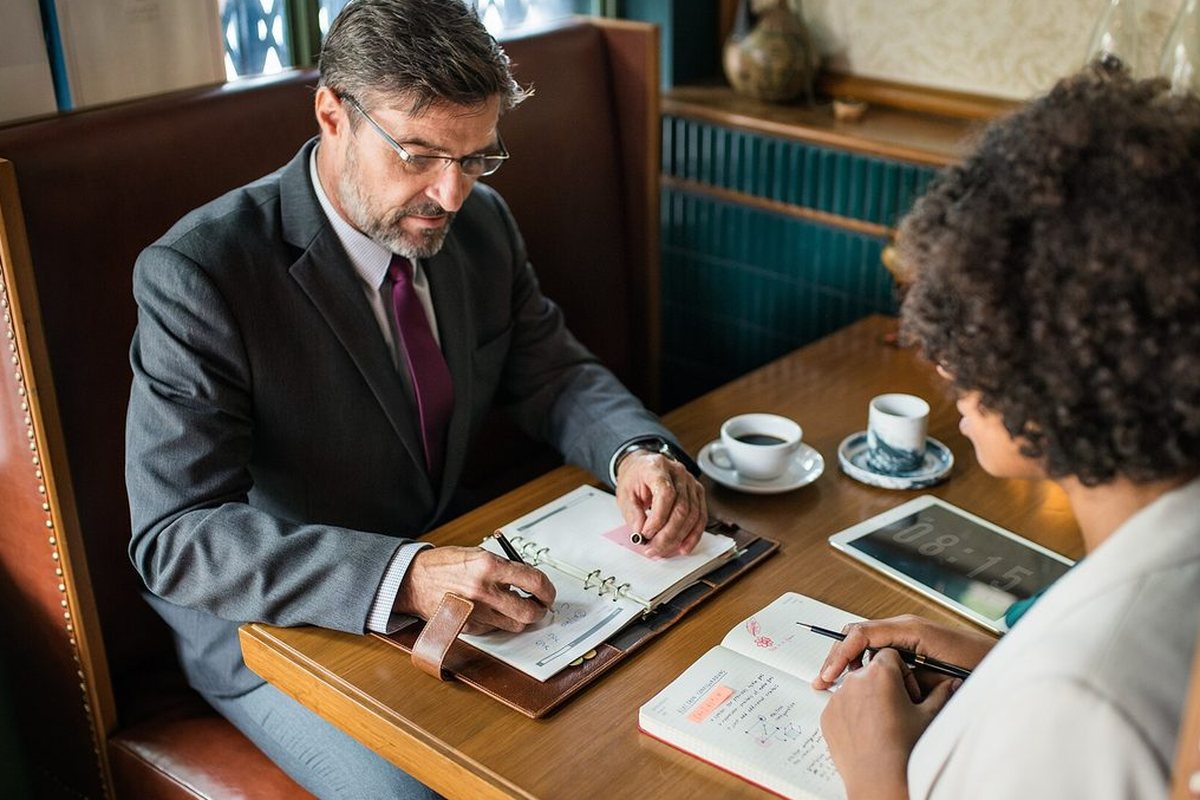 Two people reviewing written notes together at a table